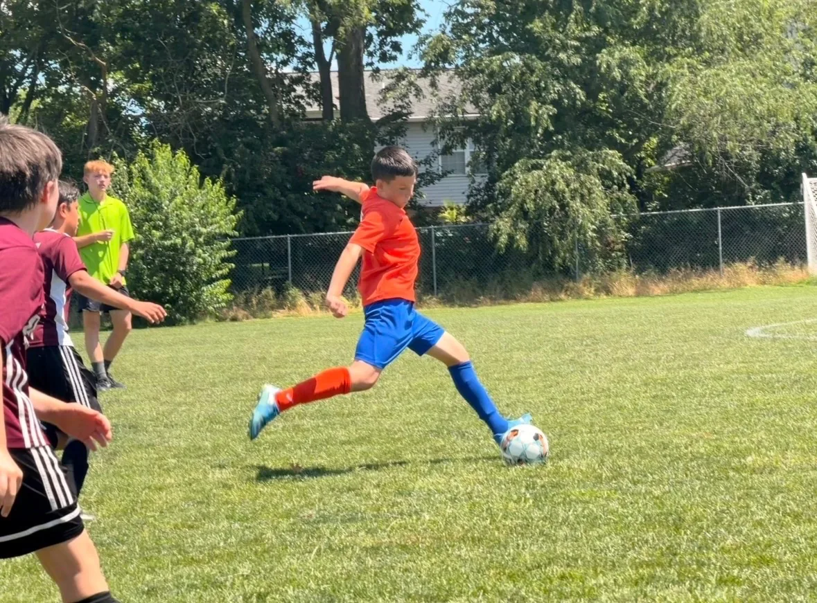 Bennett Thatcher striking the ball during a soccer match