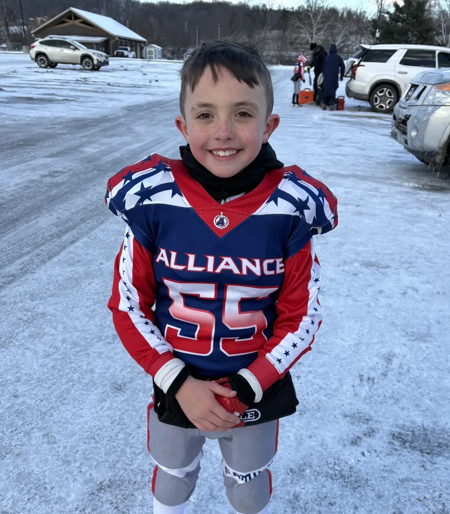 Levi Shearer standing in his youth football uniform